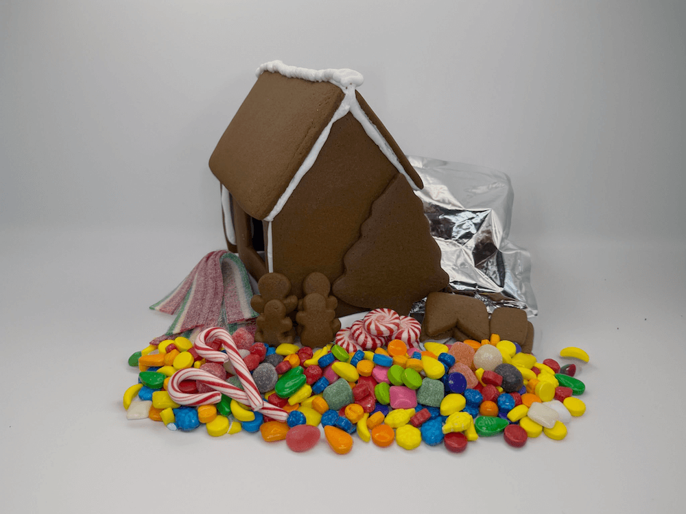 Gingerbread house with candy decorations on a white background