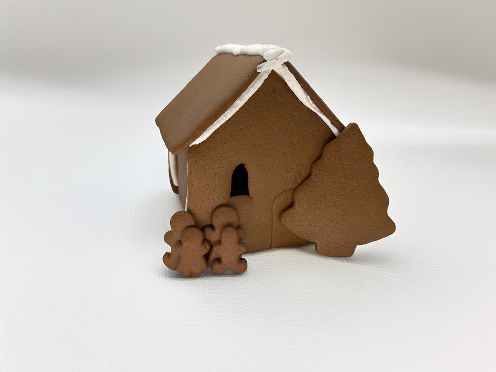 Assembled gingerbread shop with a tree on a white background