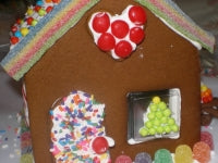 Gingerbread house with colorful decorations on a white background