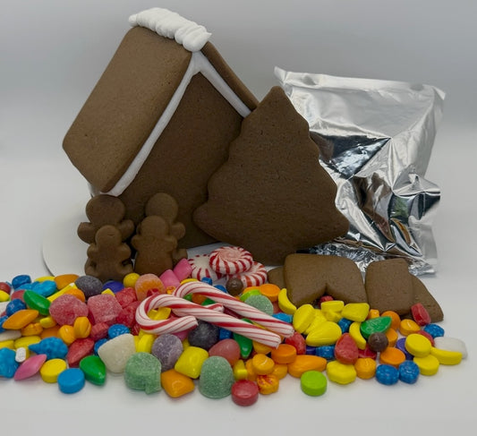 Gingerbread house kit with candy and foil on a white background