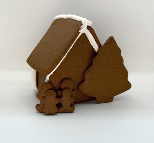 Gingerbread house with tree and gingerbread people on a white background