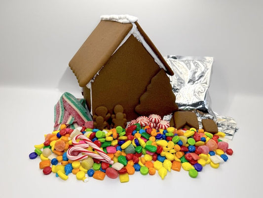 Gingerbread house with colorful candies on a white background