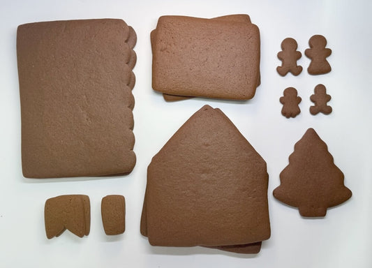 Gingerbread house kit pieces on a white background
