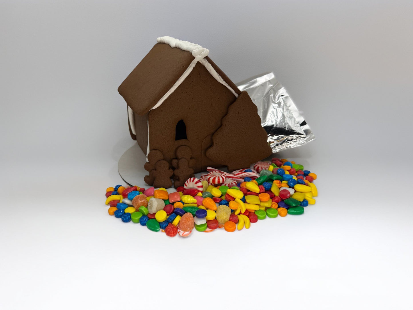 Gingerbread assembled shop with colorful candy base on a white background