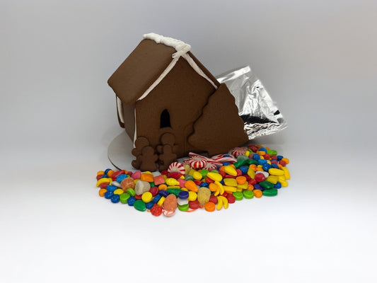 Gingerbread assembled shop with colorful candy base on a white background