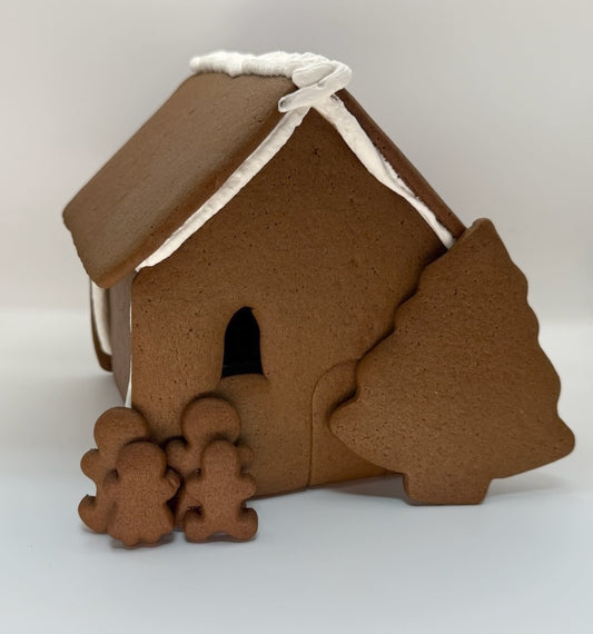Gingerbread shop with tree and cookies on a white background