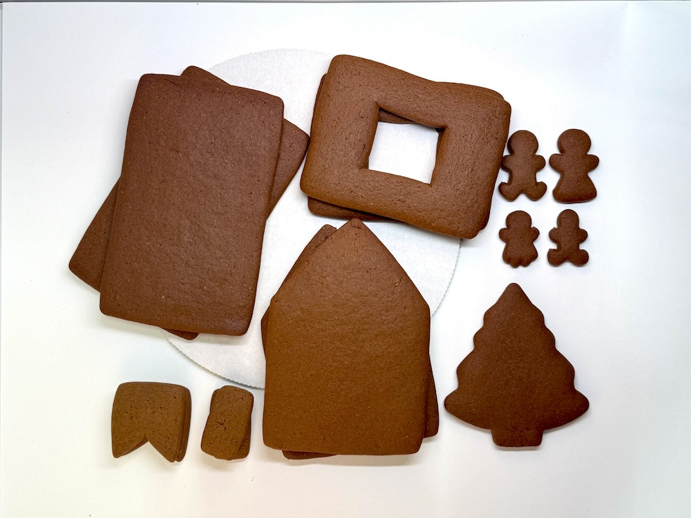 Collection of gingerbread house pieces on a white background
